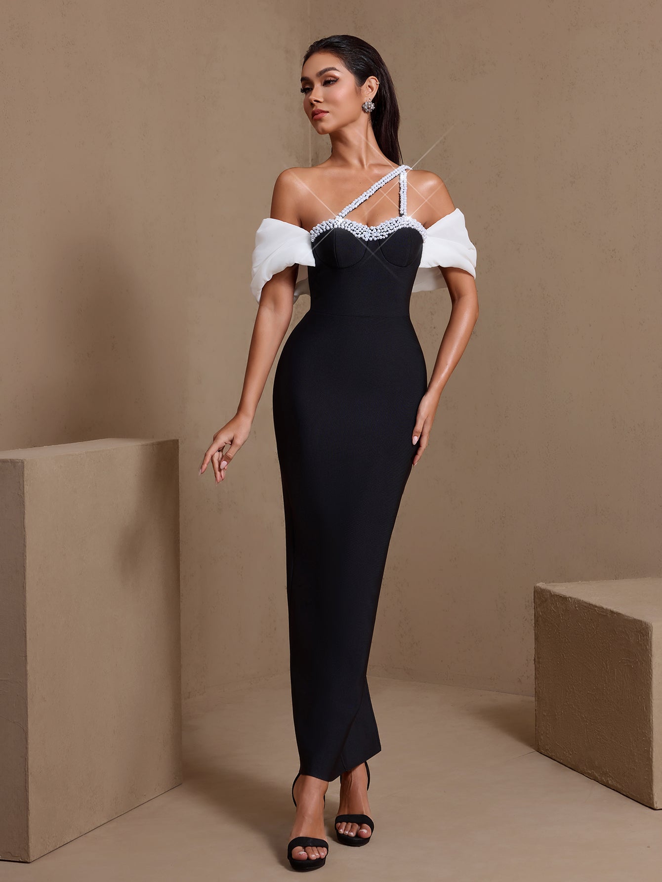 Asymmetric pearl-embellished bandage maxi dress, angled front view