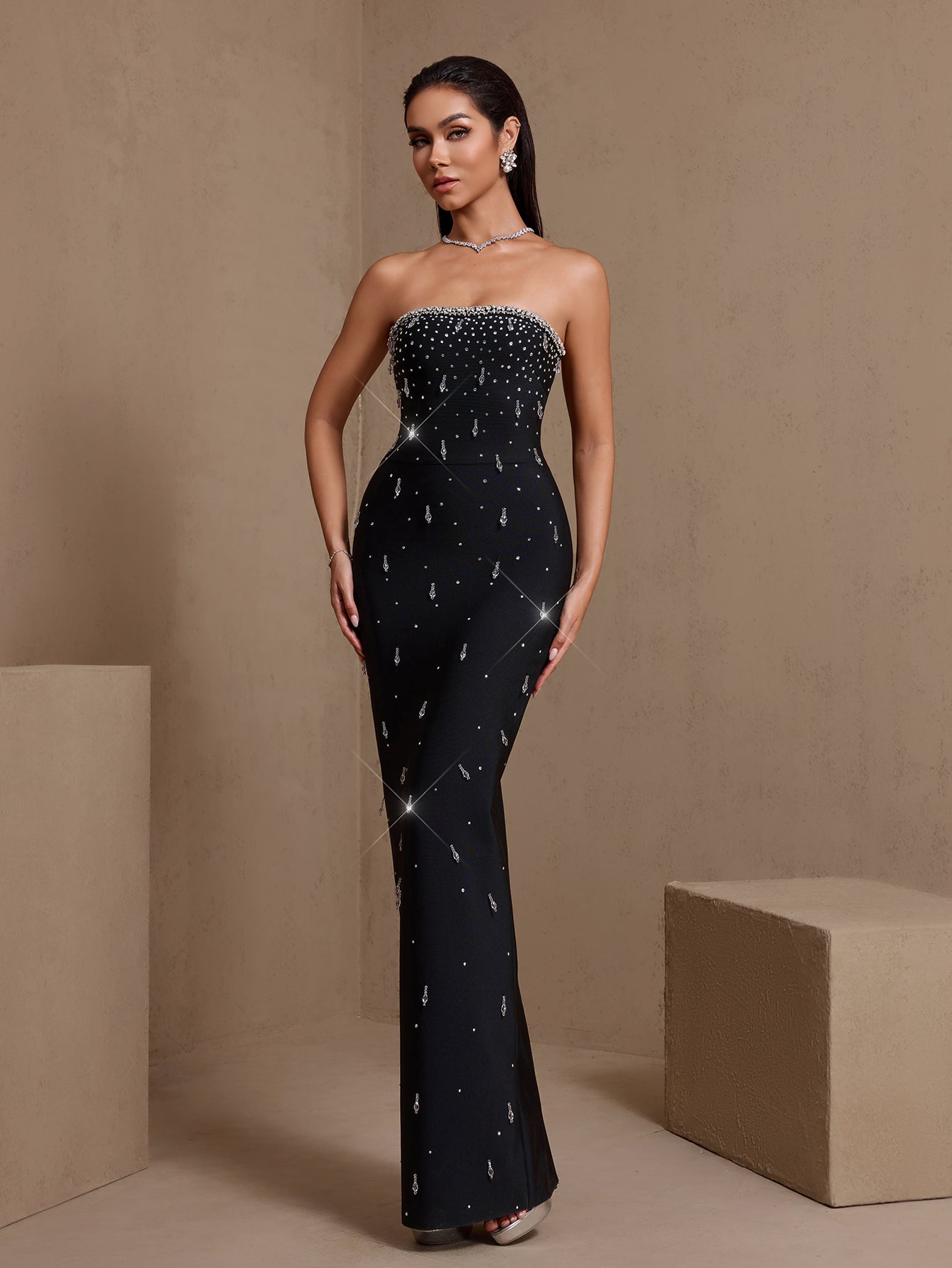 Black crystal-embellished strapless bandage maxi dress, angled front view
