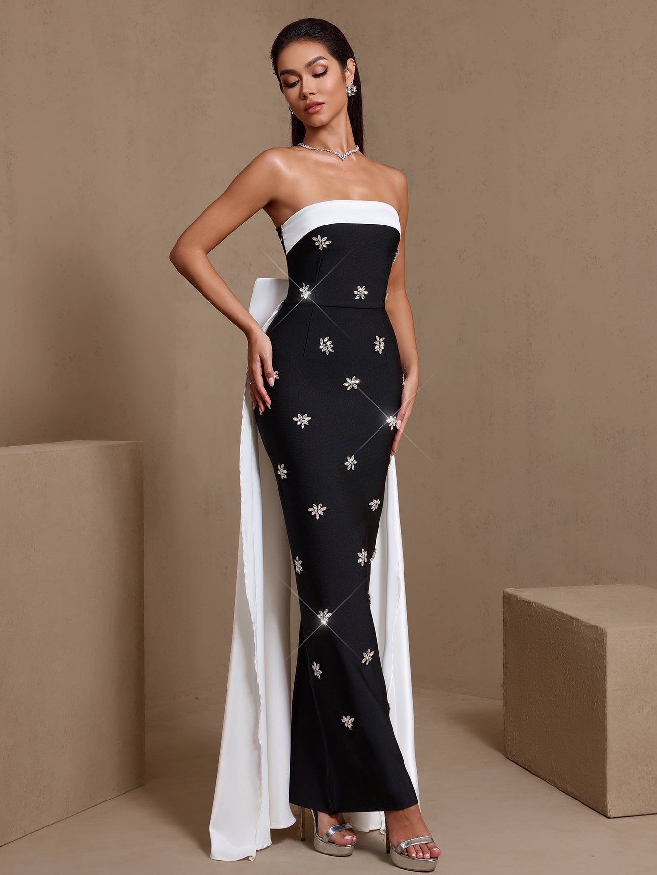 Black rhinestone bow sash strapless bandage maxi dress, angled front view