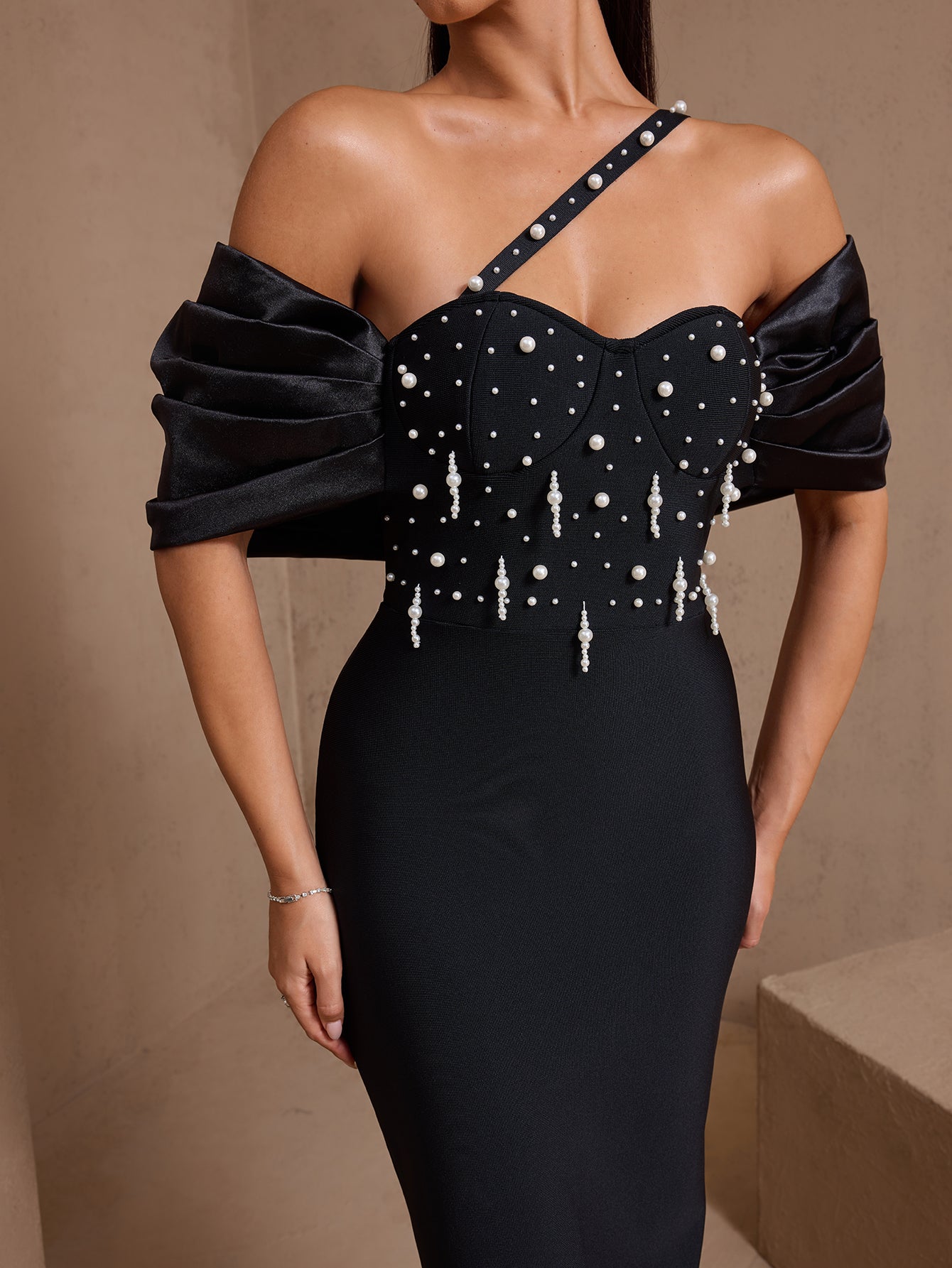 Black asymmetric pearl cascade bandage maxi dress, full-length front view