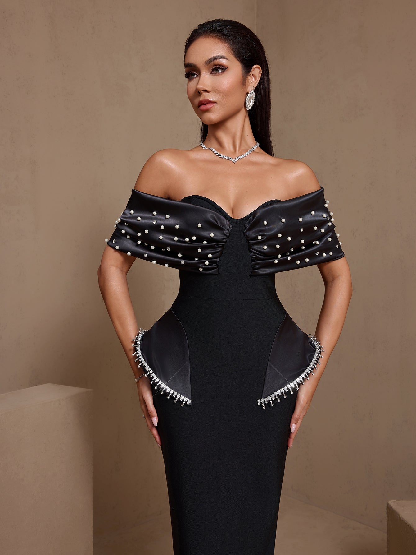Black pearl-embellished off-shoulder bandage maxi dress, front detail